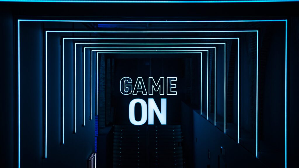 Blue neon "GAME ON" sign leading to the hallway at a gaming expo